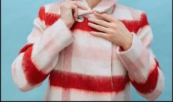 Model in a red and white plaid coat