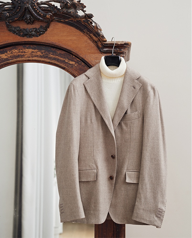 Taupe blazer with cream turtleneck on an antique mirror