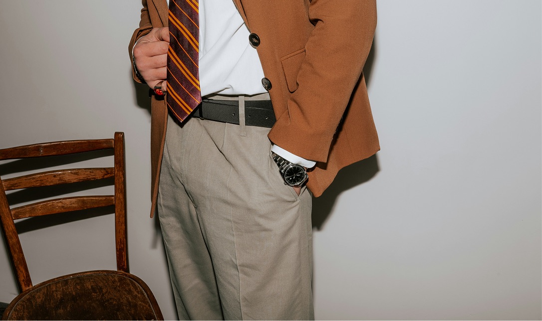 Brown blazer with striped tie and watch